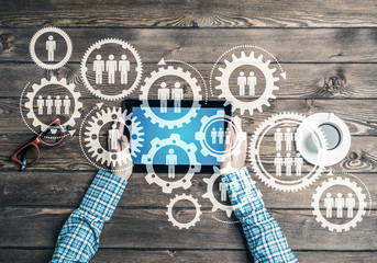 Concept of teamworking and connection with gears mechanism and tablet pc