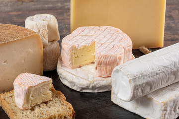 different delicious French cheeses on straw