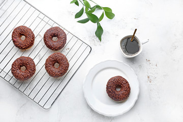 Tasty donuts with cup of coffee on white background