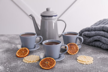 Composition with hot tea and waffles on table
