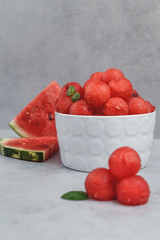 Balls of watermelon. Fruit salad with watermelon balls and mint in a white plate.