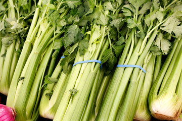 Obraz premium Several stalks of celery on display at a local farmers market.