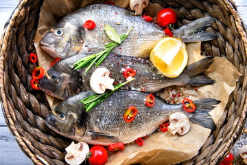 Fresh dorado fish and ingredients in bowl