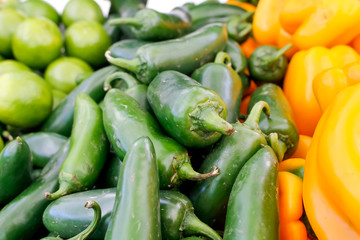 Several Jalapeño peppers on display at a local farmers market