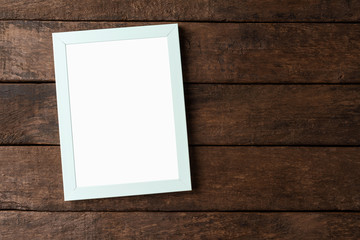 Photo frame with copyspace on wooden background