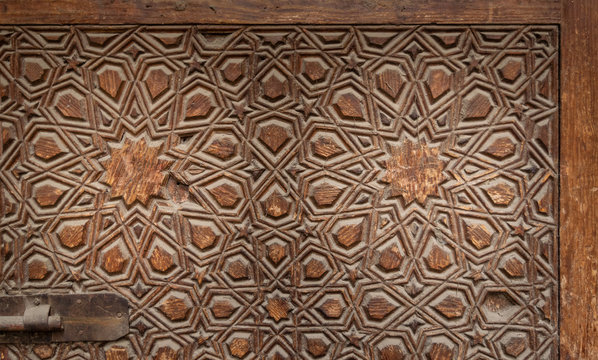 Geometrical engraved decorations of an aged wooden ornate door leaf, Old Cairo, Egypt