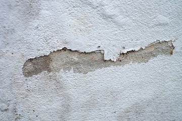 Cracks on the white wall or floor of building.