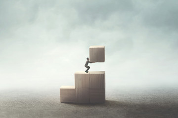 man carrying wooden block to build his future