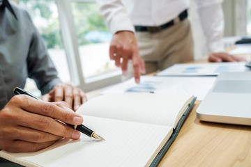 Business team brainstorming and discussing with financial data and report graph. Teamwork meeting working concept.