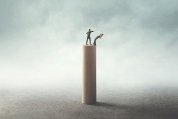 two men fighting on a high tower