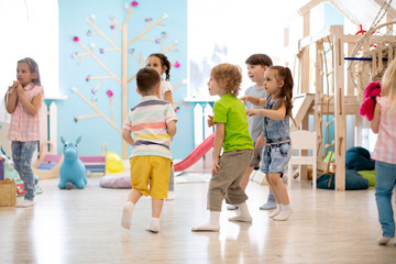 Fototapeta na wymiar Preschool children run, play educational games in kindergarten or daycare