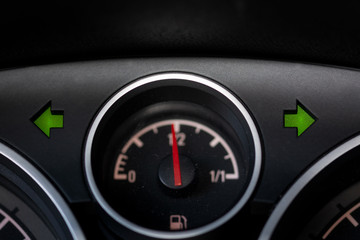 Naklejka premium Warning light and fuel gauge on the dashboard of a car