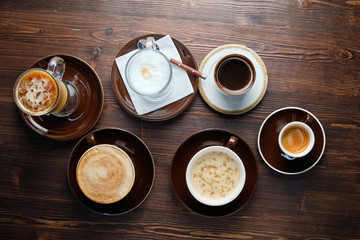 Cappuccino on a brown wooden background. Menu
