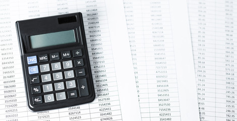 Calculator on white paper with numbers. Business and Finance accounting concept.