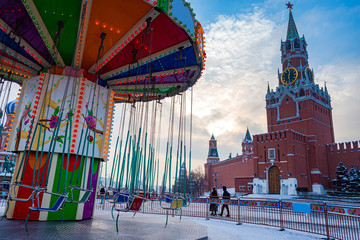 Obraz premium Russia. Moscow. New year on red square. Christmas carousel at the Kremlin wall. Fragment of the Christmas market at the Kremlin. New year in the Russian capital. Travel to Moscow in winter.