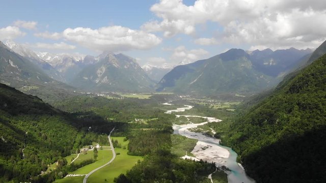 Amazing Landscape Aerial. Alpine River In Green Valley Under Alps and Snowcapped Summits, Slovenia, Europe