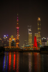 Obraz premium A Beautiful night around the Bund area in Shanghai city , this viewpoint offers the best spot for watching the spectacular skyline of this massive city with the most famous shanghai tower.