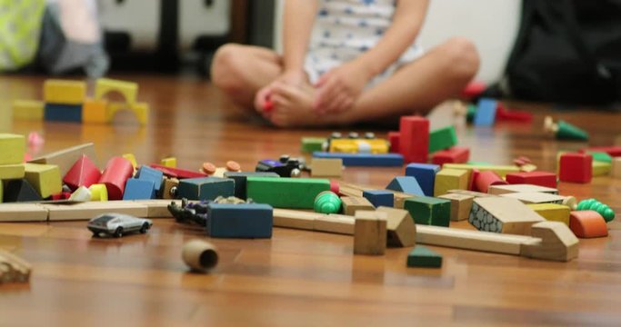 Happy cute candid toddler playing with toys in the evening wearing pajamas