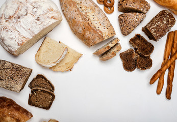 Different types of bread on a white background. Top view. Copy space.