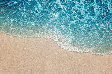 Fototapeta na wymiar Wave and sand. Beach background.