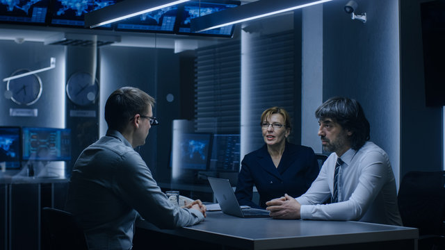 On a Job Interview Two Senior Managers Ask Young Candidate Questions. Secret Service Recruiting Talented Young Man. Serious People Working in Government Agency.