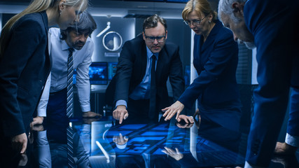 Diverse Team of Government Intelligence Agents Standing Around Digital Touch Screen Table and...
