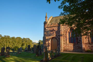 Fototapeta na wymiar The Parish Church of Farnell lit up by the Golden evening sun.