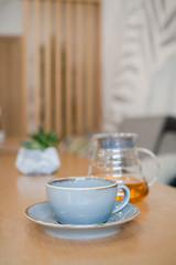 herbal tea in a transparent glass teapot in the interior of a modern Scandinavian cafe