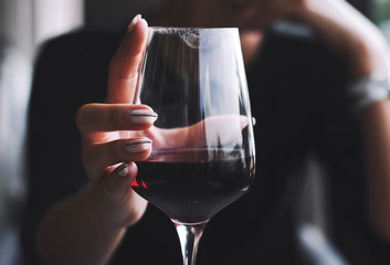 Girl holding a glass of red wine