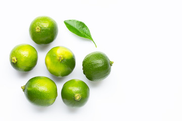 Limes with leaf isolated on white background.