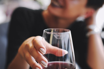 Girl holding a glass of red wine