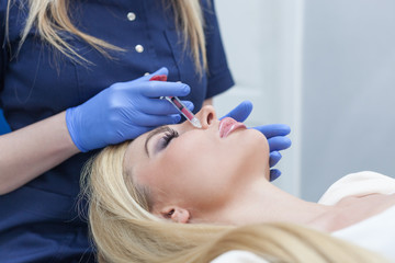 Fototapeta premium woman at beauty and health clinic hyaluronic acid injection