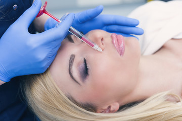 woman at beauty and health clinic hyaluronic acid injection