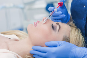 woman at beauty and health clinic hyaluronic acid injection