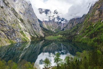 Naklejka na ściany i meble Scenic mountain panorama with green meadows and idyllic turquoise Lake Oberer