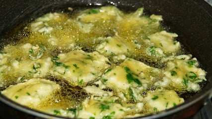 Cekodok frying in boiling oil. Popular traditional fritter snack also called jemput-jemput or cucur in Malaysia, Brunei and Indonesia.