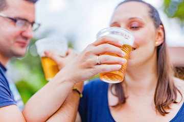 Friends enjoying drinking beer in the backyard.