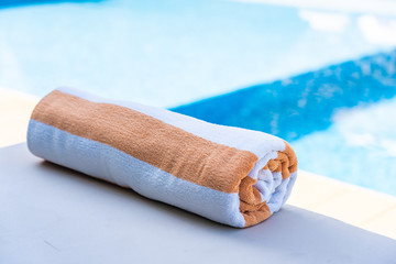 Towel on bed around swimming pool in hotel resort