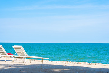 Beautiful umbrella and chair around beach sea ocean with blue sky for travel