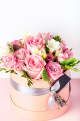 Beautiful and tender bouquet of flowers in the hat box,