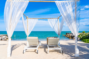 Fototapeta na wymiar Beautiful umbrella and chair around beach sea ocean with blue sky for travel