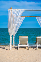 Beautiful umbrella and chair around beach sea ocean with blue sky for travel