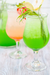 A variety of soft drinks. Assortment of soft drinks. Tarragon lemonade, Strawberry lemonade, Pear lemonade. Lemonade on a light background.