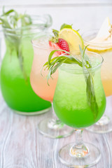 A variety of soft drinks. Assortment of soft drinks. Tarragon lemonade, Strawberry lemonade, Pear lemonade. Lemonade on a light background.