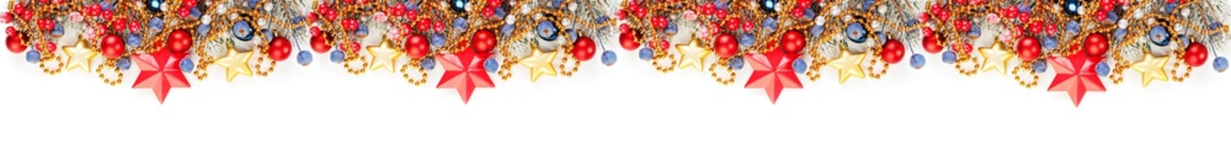 Christmas banner with green Xmas tree branch, winter holly berries, red baubles and gold stars isolated on white background