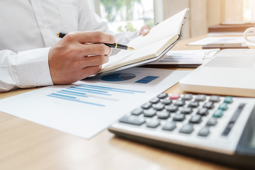 Business team brainstorming and discussing with financial data and report graph. Teamwork meeting working concept.