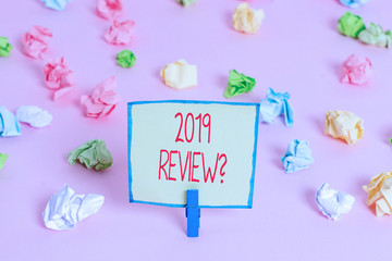Text sign showing 2019 Review Question. Business photo text remembering past year events main actions or good shows Colored crumpled papers empty reminder pink floor background clothespin