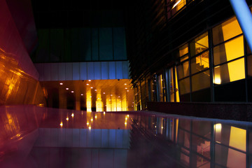 dark foyer of a modern building illuminated by yellow light