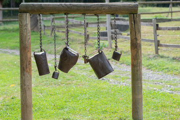 old cowbells hanging on ropes