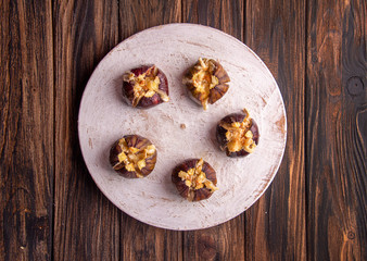 Ripe figs baked with cow's-milk cheese brie and camambert and sprinkled with bread crumbs decorated with mint leaves  on wooden background. Healthy eating concept. top view. copy space